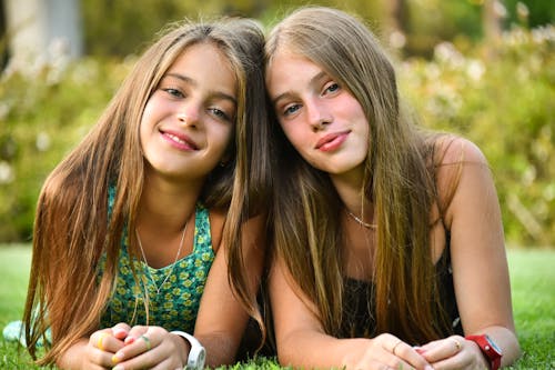 Two Pretty Teenage Girls on Green Grass