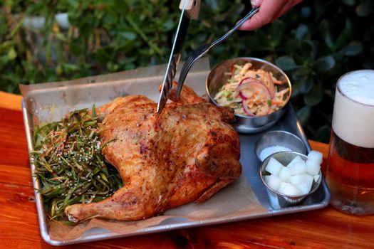 A Roasted Chicken on Metalic Board, Additives and Beverage 