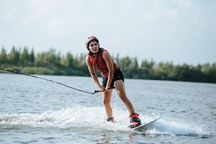 Woman Doing Wakeboarding On Lake