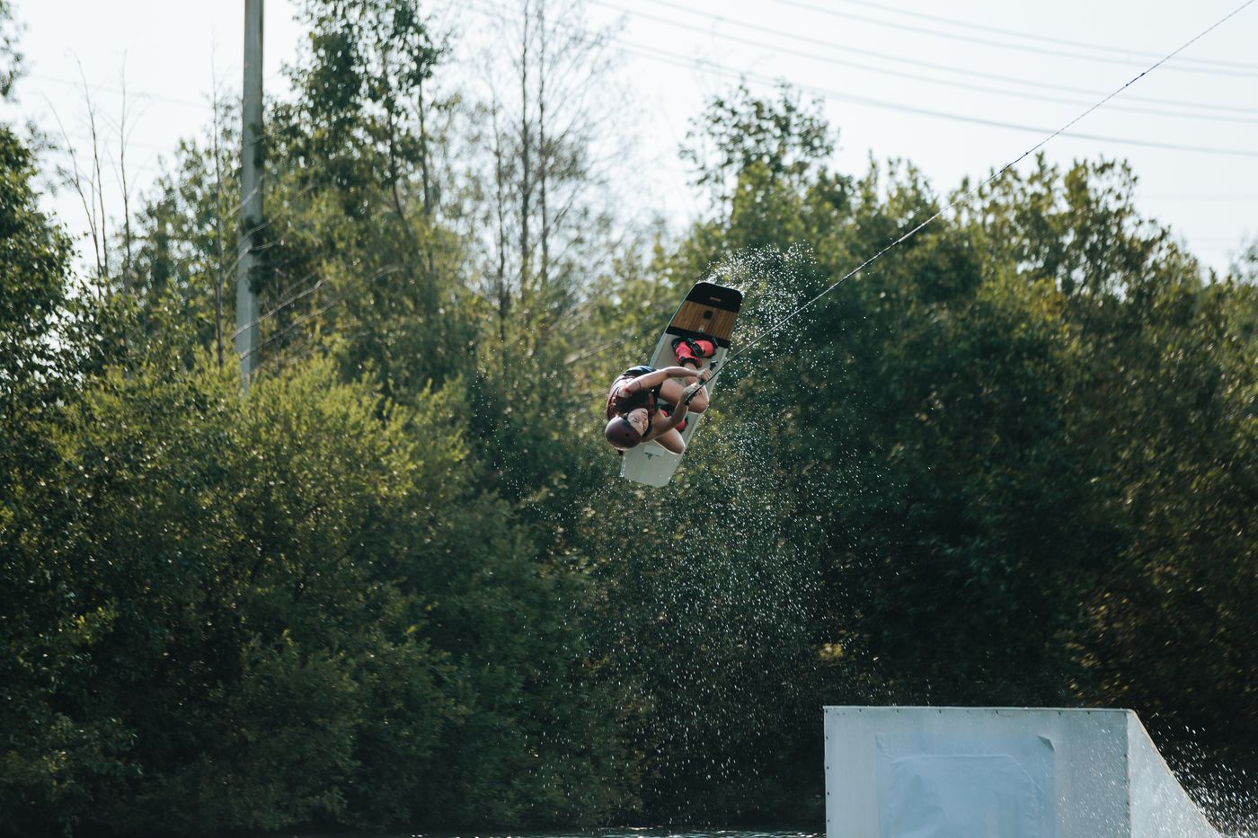 Woman wakeboarding at an outdoor water-sports park