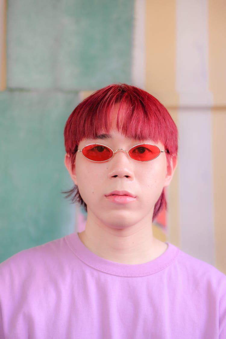 Man With Red Dyed Hair, Pink Shirt And Tinted Glasses