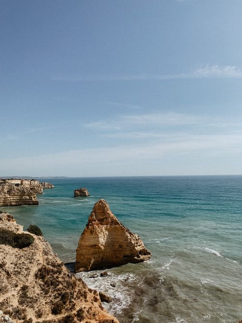 Free Majestic cliffs and serene blue waters define the Algarve coast, Portugal. Stock Photo