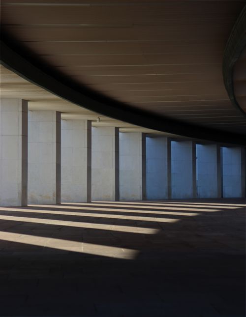 Free A striking view of architectural shadows and light play under a modern urban bridge. Stock Photo