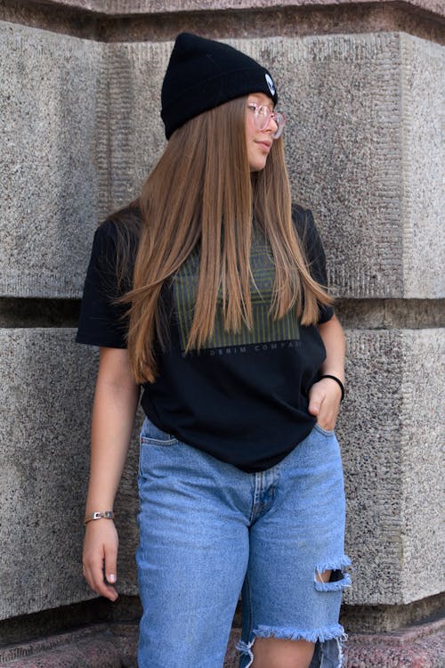Woman in Black Shirt and Ripped Jeans Posing 