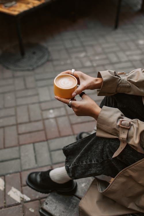 Free Person Holding a Cup of Cappuccino Stock Photo