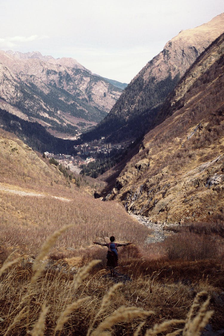 Admiring Mountain View With Outstretched Arms