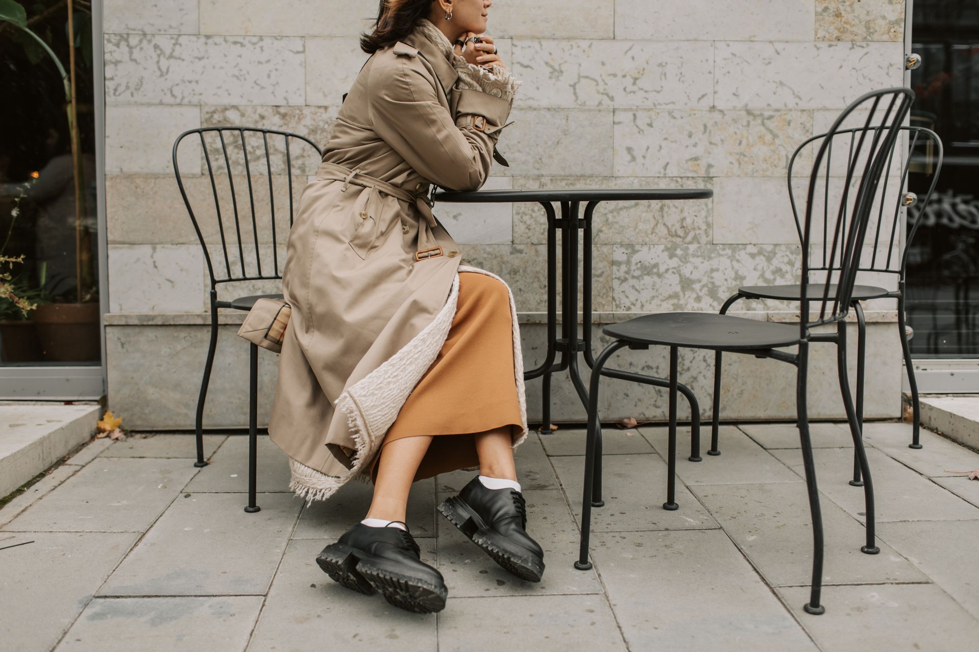 Woman Sitting at Metal Chair with Table
