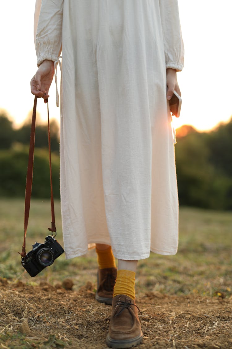 View On Womans Legs In White Loose Dress