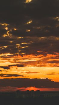 A breathtaking cityscape silhouette against a dramatic golden sunset sky.