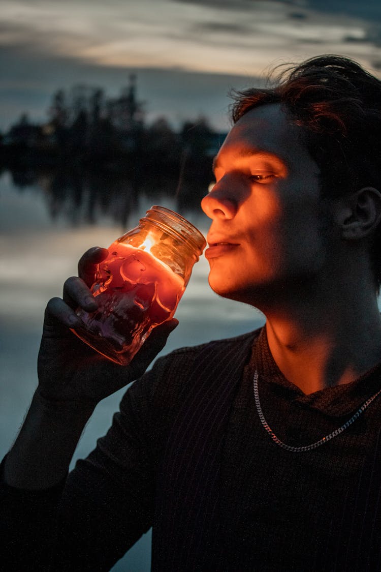 A Man Holding A Burning Candle