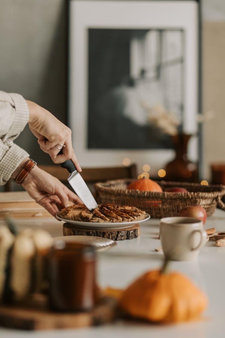 A Person Slicing A Pie