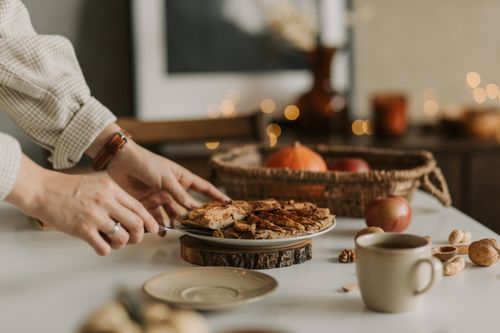 Free Cozy autumn table setting with sliced apple pie, coffee, and rustic decor. Stock Photo