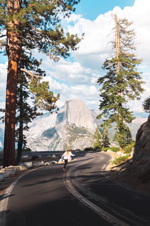 A Person Longboarding on Glacier Point Road