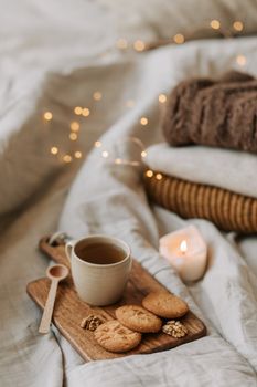 Warm and inviting scene featuring tea and cookies on a wooden board, perfect for a cozy morning.