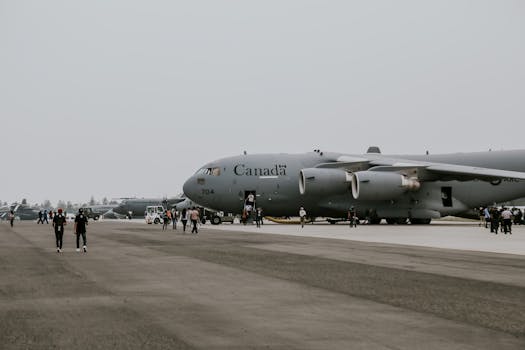 C-17 Globemaster being prepared at a Canadian airstrip with personnel nearby.