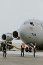 People Standing by the Nose of C-17 Airplane