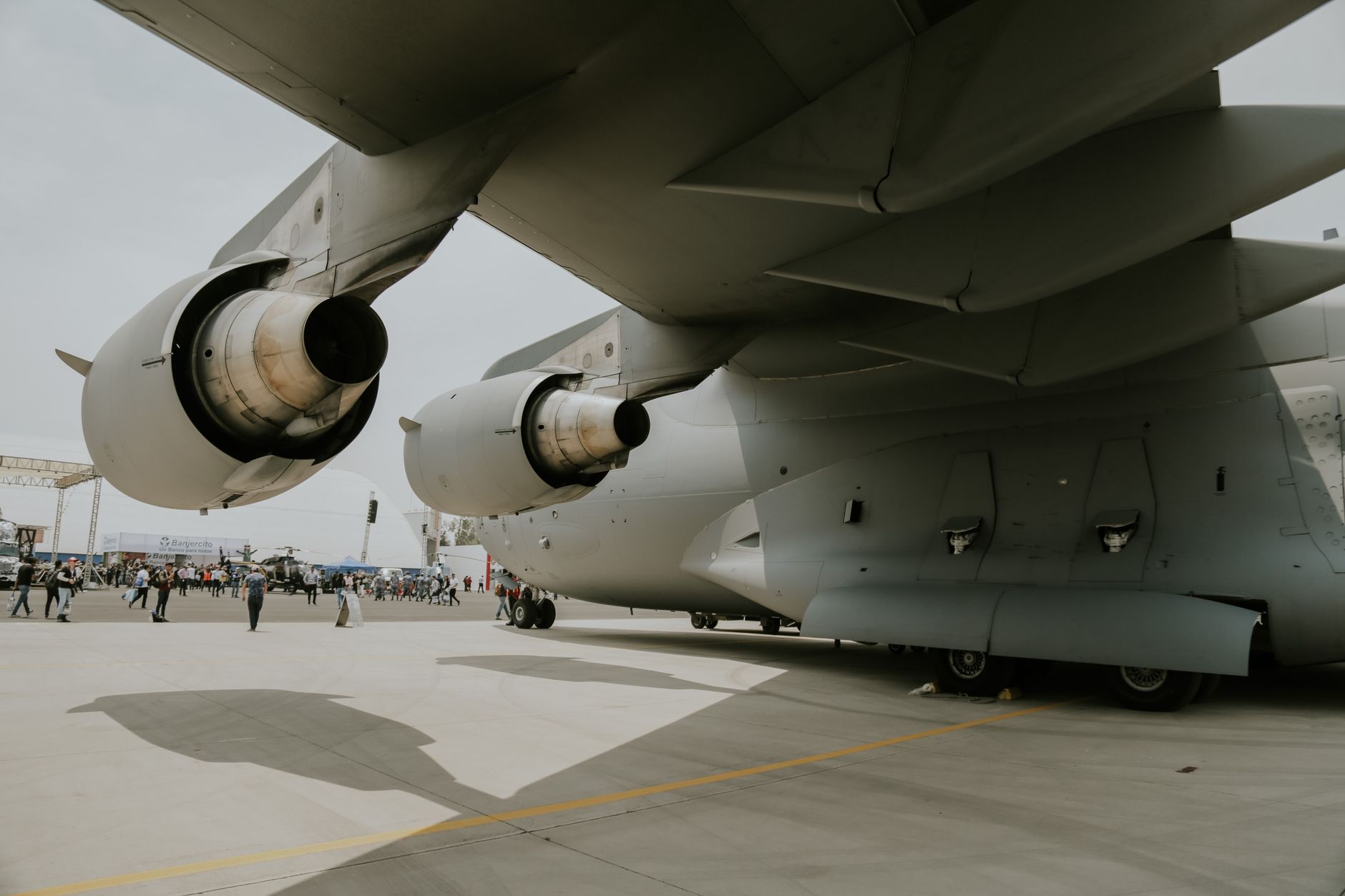Close-up of a C-17 aircraft's engines and wings on an airstrip, showing its massive structure.