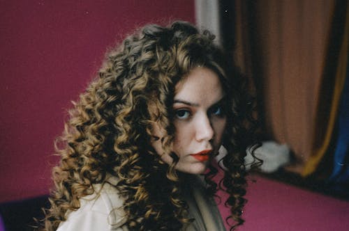 Portrait of a Beautiful Woman with Brown Curly Hair 