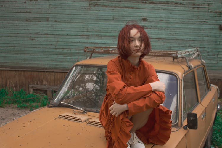 Young Woman With Red Hair Sitting On Car Mask