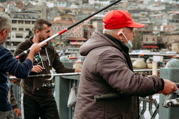 Group Of Men Fishing On The Riverside