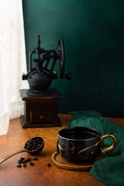 Old Fashioned Coffee Grinder and Coffee Cup