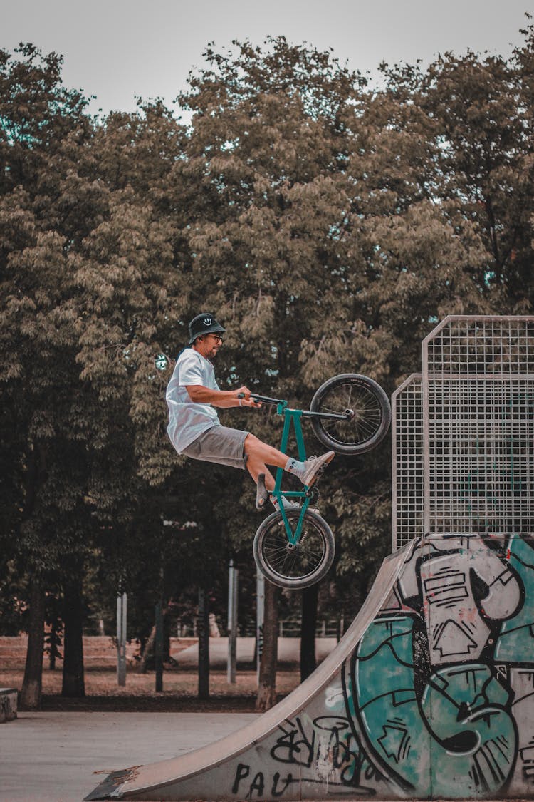 A Man Doing Tricks On A Ramp While Riding A BMX Bike