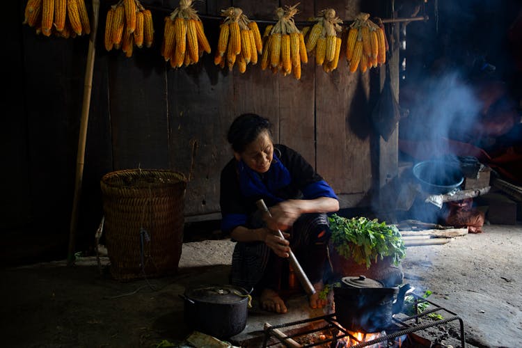 Woman Sitting And Cooking