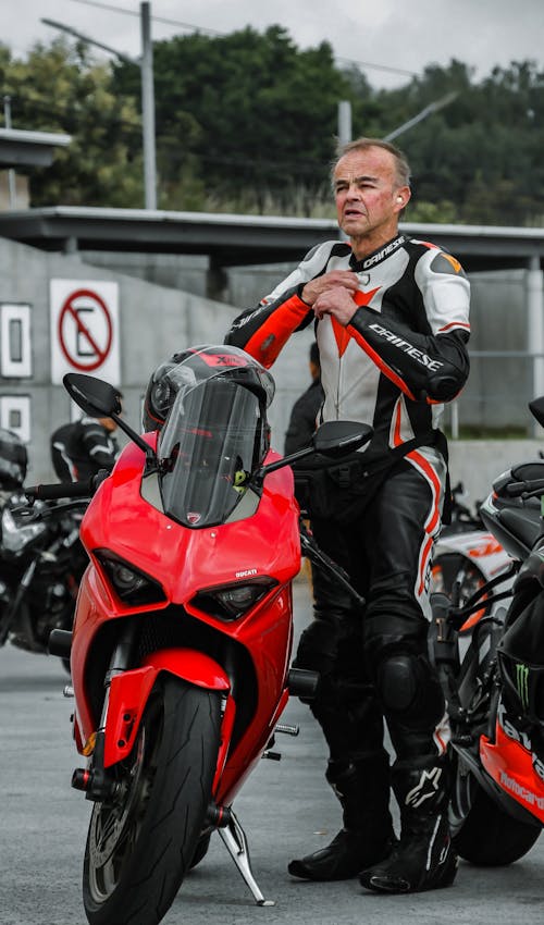 Man Standing Beside a Motorcycle