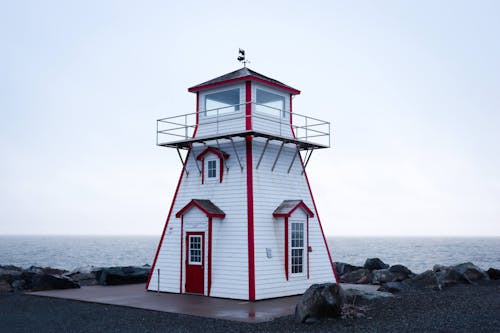 White and Red Wooden House Near the Ocean 