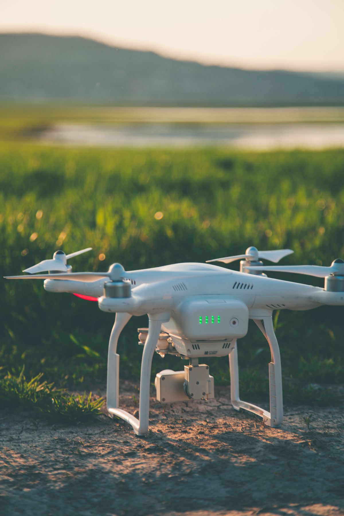 Cloudline Scout Pro quadcopter resting on grass at sunset