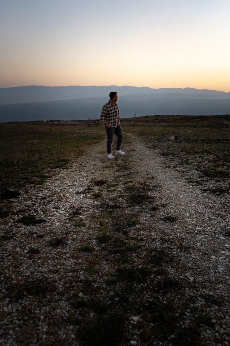 Man Walking Path In Field On Sunset