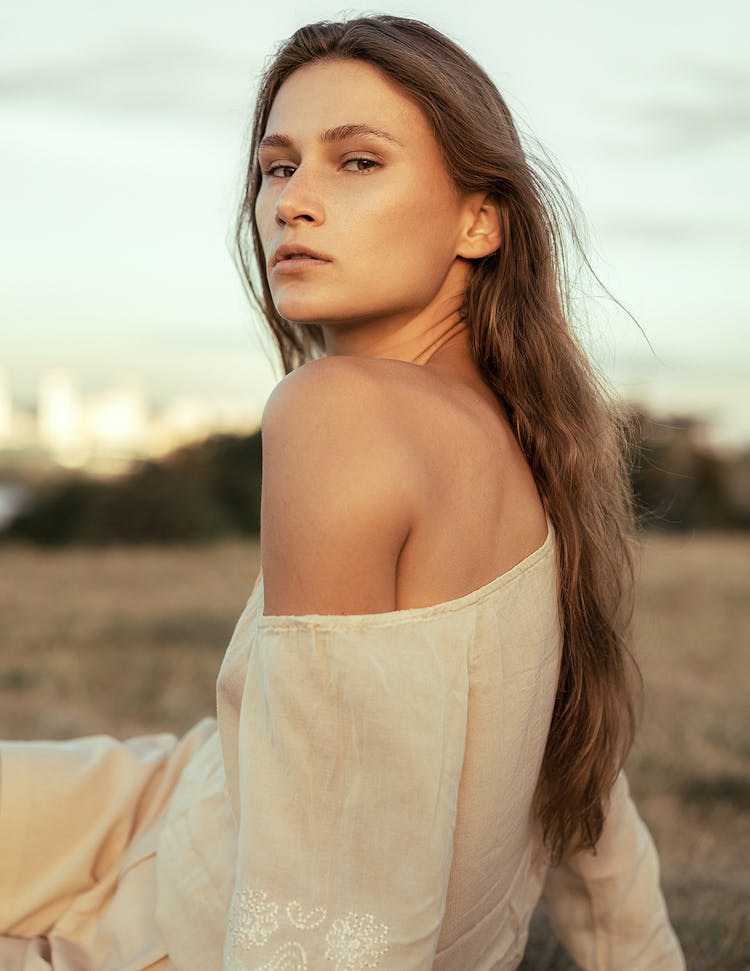 A Female Looking At Camera Over Her Shoulder 