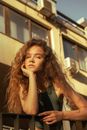 Girl with Long Curly Hair Leaning on Railing