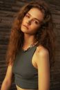 Girl with Brown Curly Hair Looking at Camera