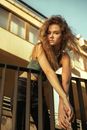 Girl with Long Hair Leaning on Railing Outdoors
