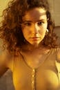 Woman with Brown Curly Hair in Sunlight