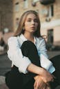 Girl in White Shirt Sitting Cross-Legged