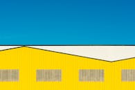 Abstract Image of a Yellow Warehouse against Blue Sky