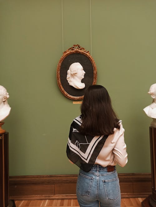 Back View of a Woman Looking at a Sculpture