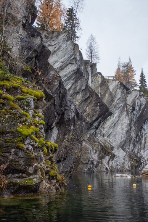 Free Captivating rock formations with autumnal trees and a calm water body in Karelia, Russia. Stock Photo