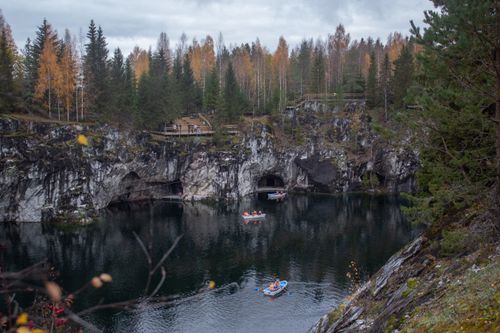 Free Discover kayakers amidst the stunning rock formations of Ruskeala Park, Karelia, during autumn. Stock Photo