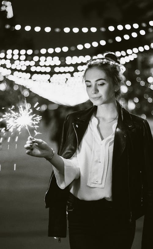Free Woman with Sparkler in Hands on Night Street Stock Photo