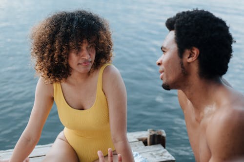 Woman in Yellow Swimsuit Talking to a Man