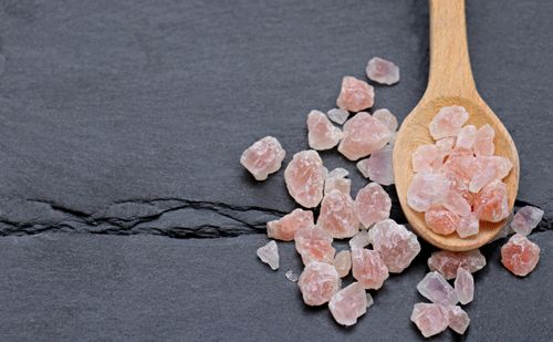 Free A wooden spoon with Himalayan pink salt crystals on a dark slate surface. Stock Photo