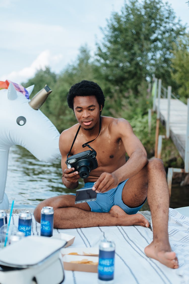 Man With Camera During Party By Lake