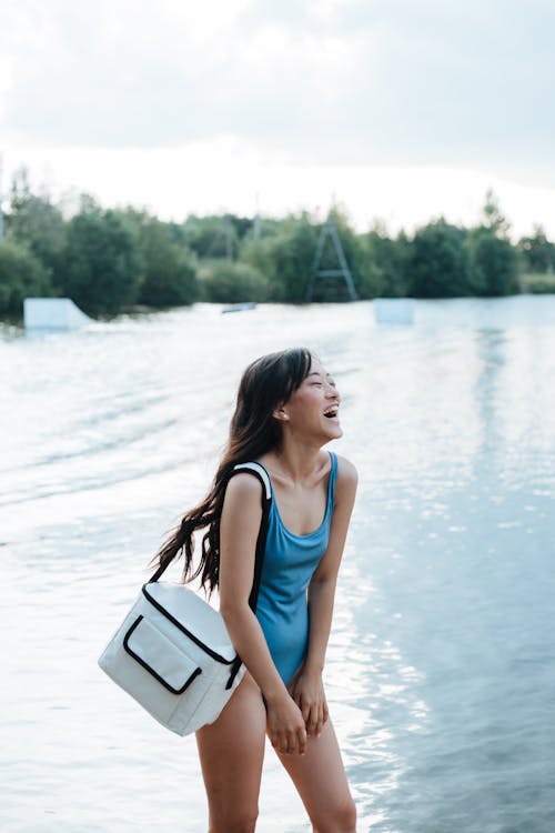Laughing Woman in Swimming Costume by Lake