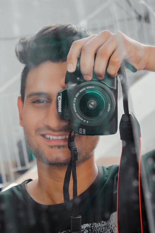 Man Holding Black Canon Eos