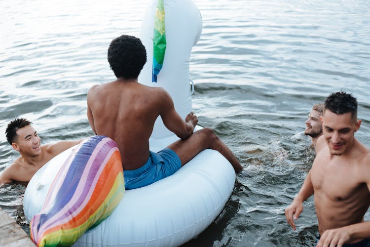 Young Men Swimming In Lake 