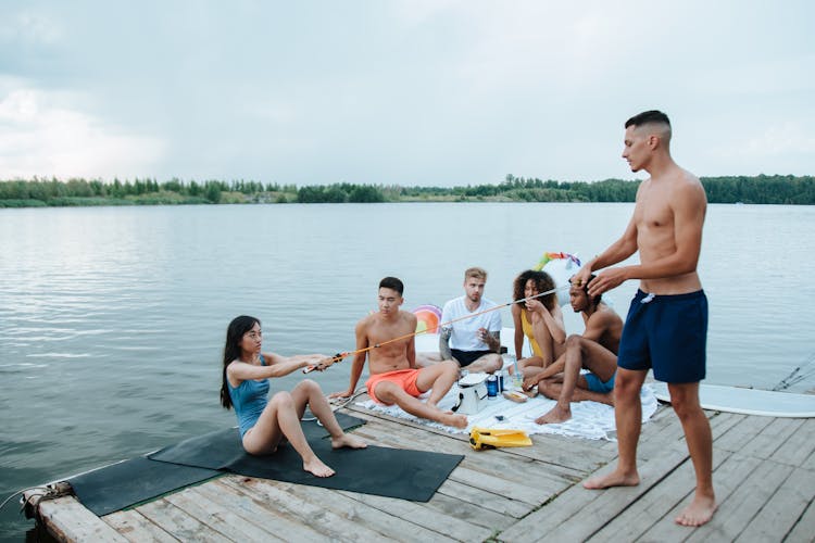 Group Of Friends Hanging Out Together Near The Lake