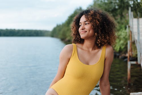 Woman in Swimsuit Sitting and Smiling